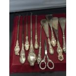 FOUR SHOE HORNS, SIX BUTTON HOOKS AND A PAIR OF SCISSORS ALL WITH HALLMARKED HANDLES