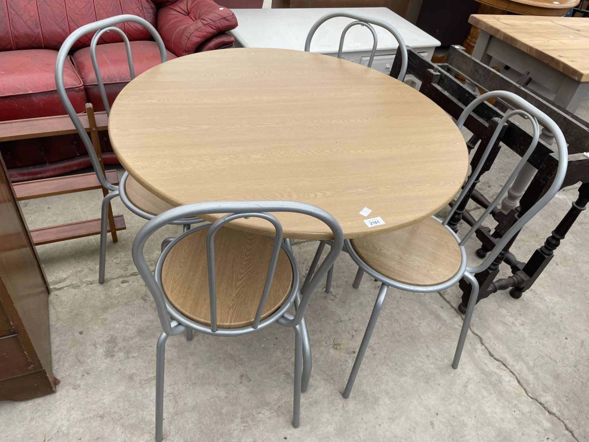 A CIRCULAR KITCHEN TABLE AND FOUR MATCHING CHAIRS