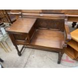 AN OLD CHARM STYLE TELEPHONE TABLE/SEAT WITH CARVED PANELS, ON TURNED LEGS