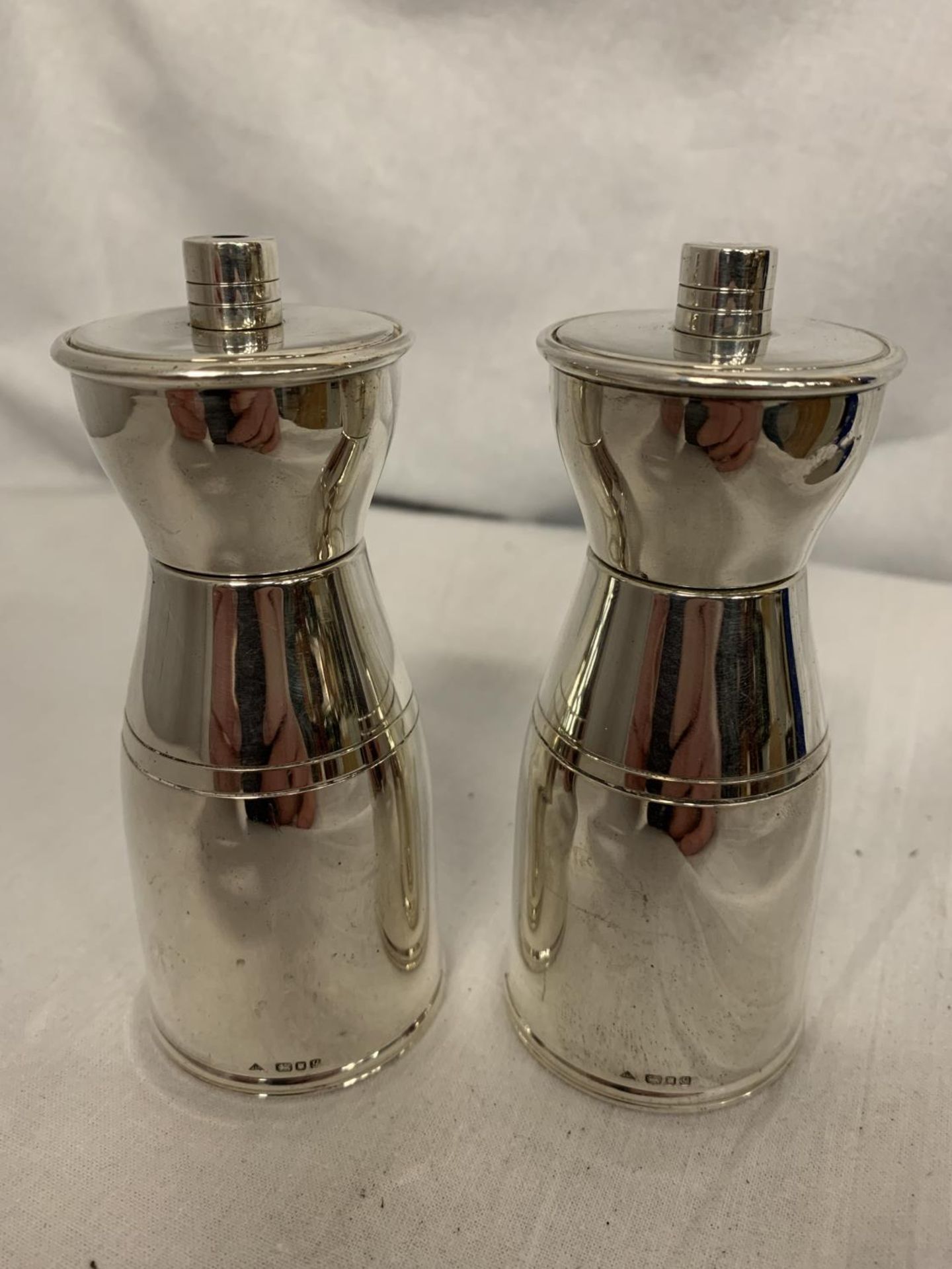A PAIR OF SILVER SALT AND PEPPER SHAKERS