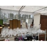 A LARGE QUANTITY OF GLASS WARE TO INCLUDE DECANTORS, SHERRY GLASSES AND BRANDY BALLOONS ETC