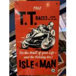 A METAL 'T.T. RACES' ISLE OF MAN SIGN - 35.5CM X 20.5CM