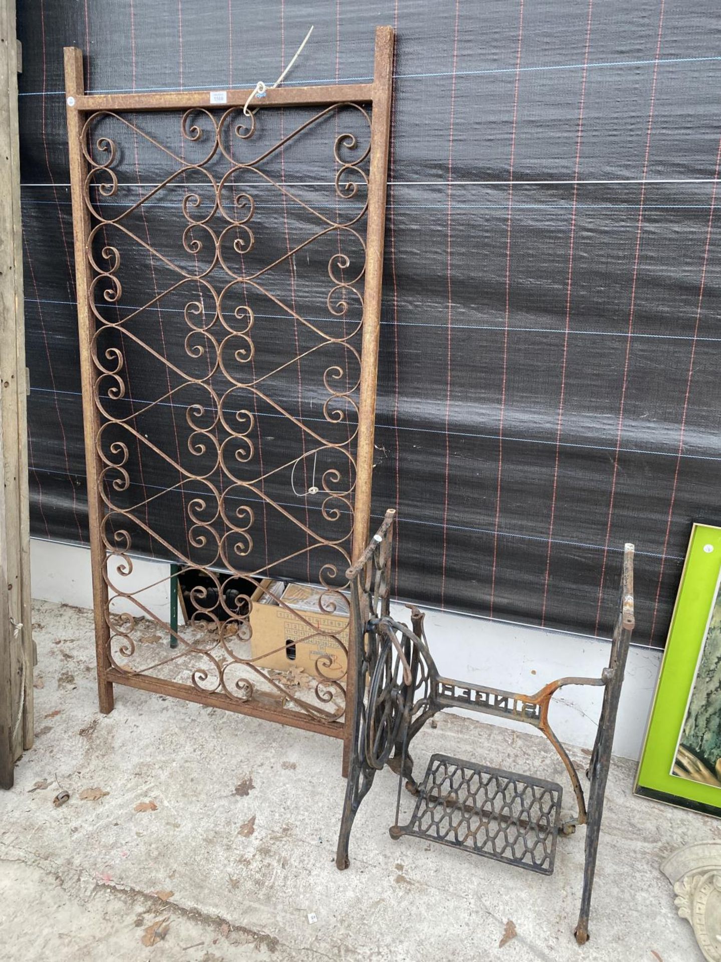 A SECTION OF DECORATIVE WROUGHT IRON RAILING AND A SINGER TREADLE BASE