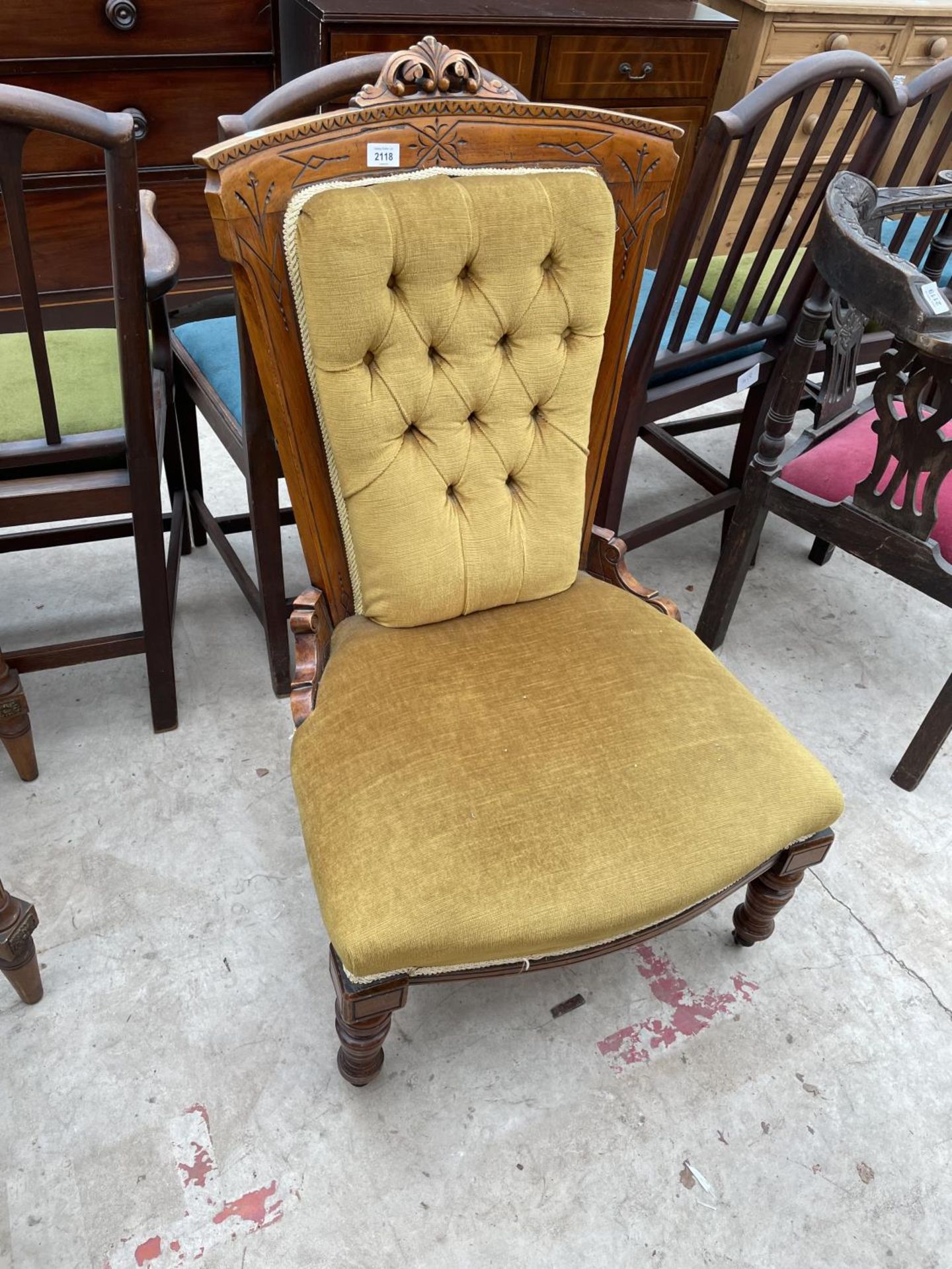 A VICTORIAN SATINWOOD NURSING CHAIR ON TURNED FRONT LEGS