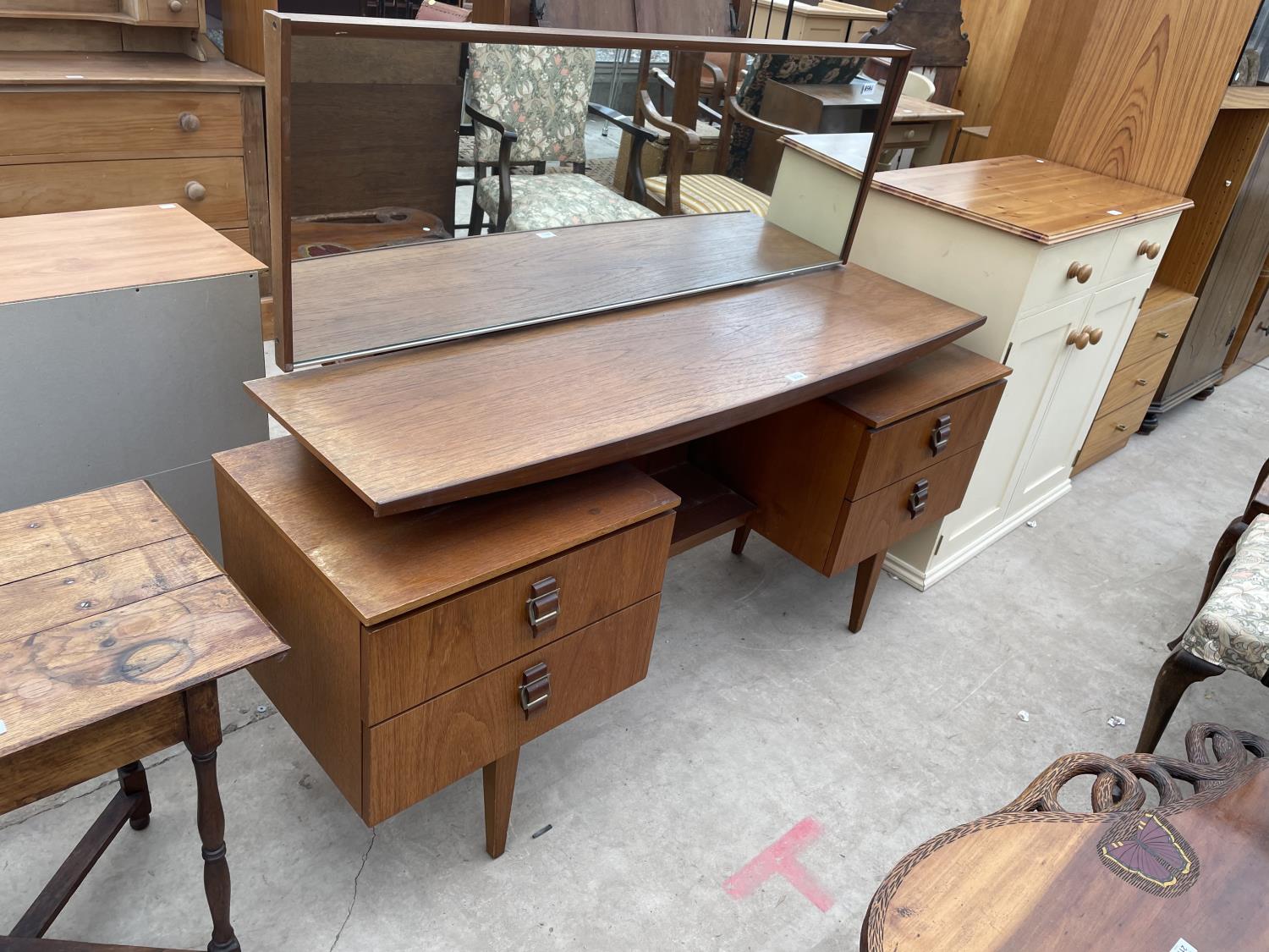 A RETRO TEAK DRESSING TABLE ENCLOSING FOUR DRAWERS WITH BELT BUCKLE STYLE HANDLES, 60" WIDE