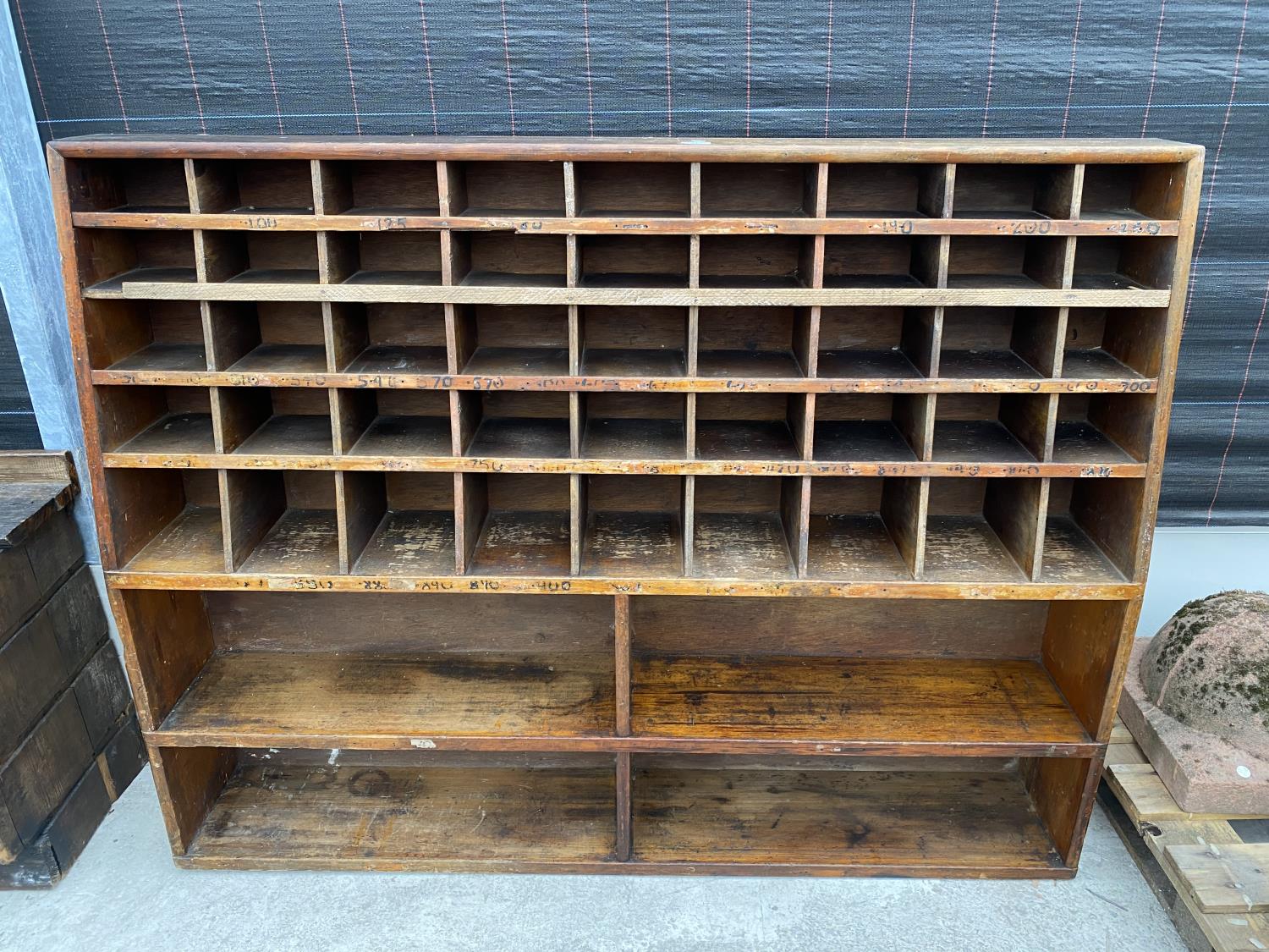 A VINTAGE WALL STORAGE UNIT WITH 45 SECTION UPPER PIGEON HOLE RACK AND LOWER 4 SECTION SHELVING