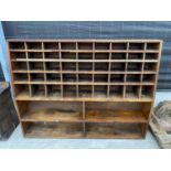 A VINTAGE WALL STORAGE UNIT WITH 45 SECTION UPPER PIGEON HOLE RACK AND LOWER 4 SECTION SHELVING