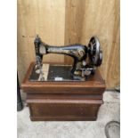 A VINTAGE SINGER SEWING MACHINE WITH WOODEN CARRY CASE