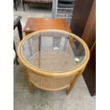 A CIRCULAR BAMBOO COFFEE TABLE WITH GLASS TOP AND CANE LOWER SHELF, 24" DIAMETER