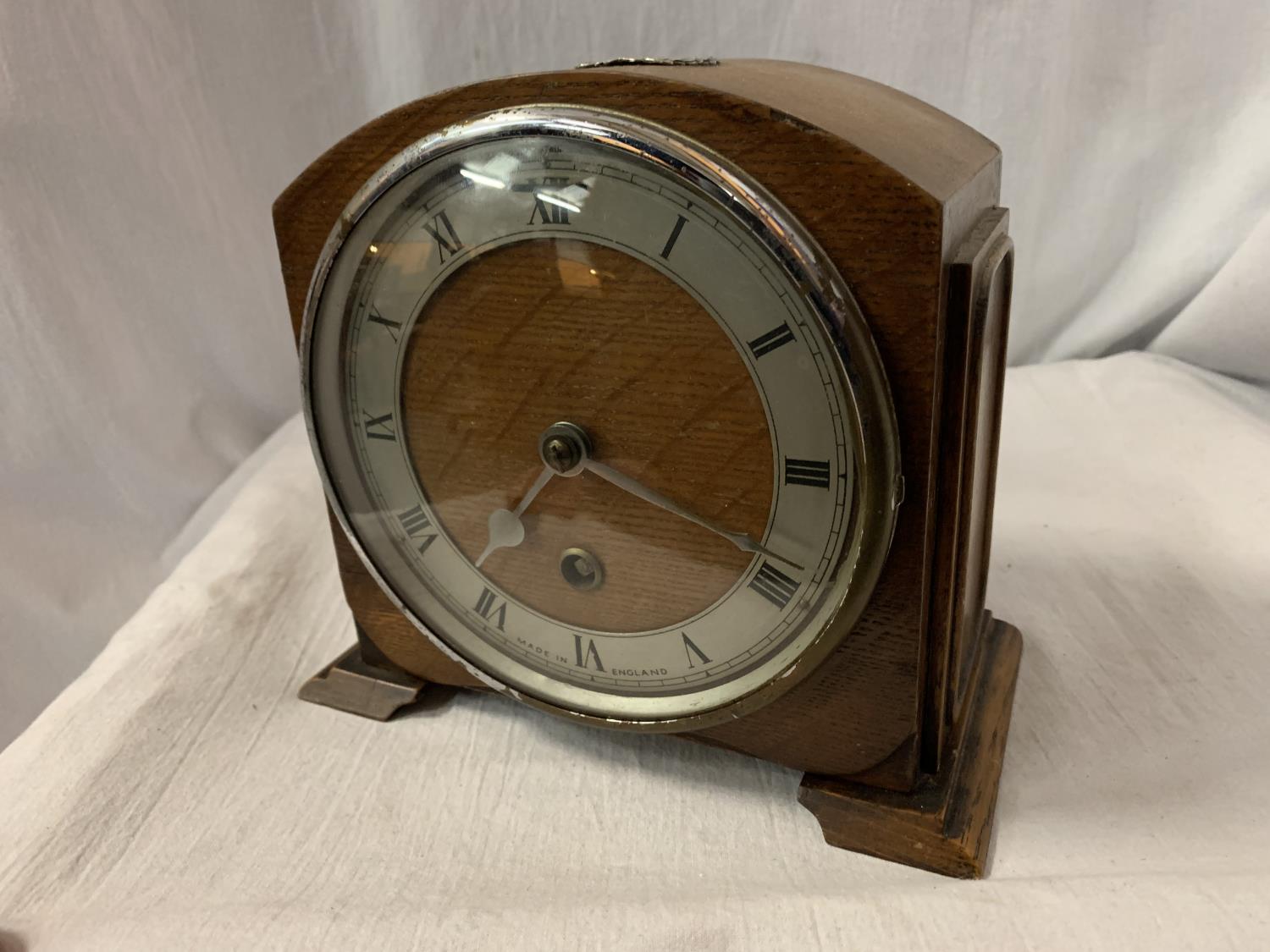 AN OAK MANTEL CLOCK WITH HALLMARKED SILVER PLATE STAMP ' ST PATRICK'S CLUB 1924 - 25'