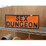 AN ILLUMINATED 'SEX DUNGEON' SIGN