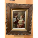 A FRAMED CRYSTOLEUM OF A COURTING COUPLE