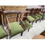 FIVE 19TH CENTURY MAHOGANY DINING CHAIRS ON SABRE LEGS, TO INCLUDE ONE CARVER