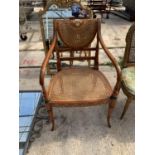 A REPRODUCTION SHERATON REVIVAL ELBOW CHAIR WITH SPLIT CANE SEAT AND BACK