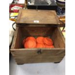 A VINTAGE GAME KEEPER'S PINE BOX WITH CLAY PIGEONS AND EMPTY CARTRIDGES