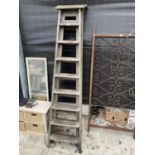 TWO VINTAGE WOODEN STEP LADDERS, ONE 7 RUNG AND ONE 8 RUNG