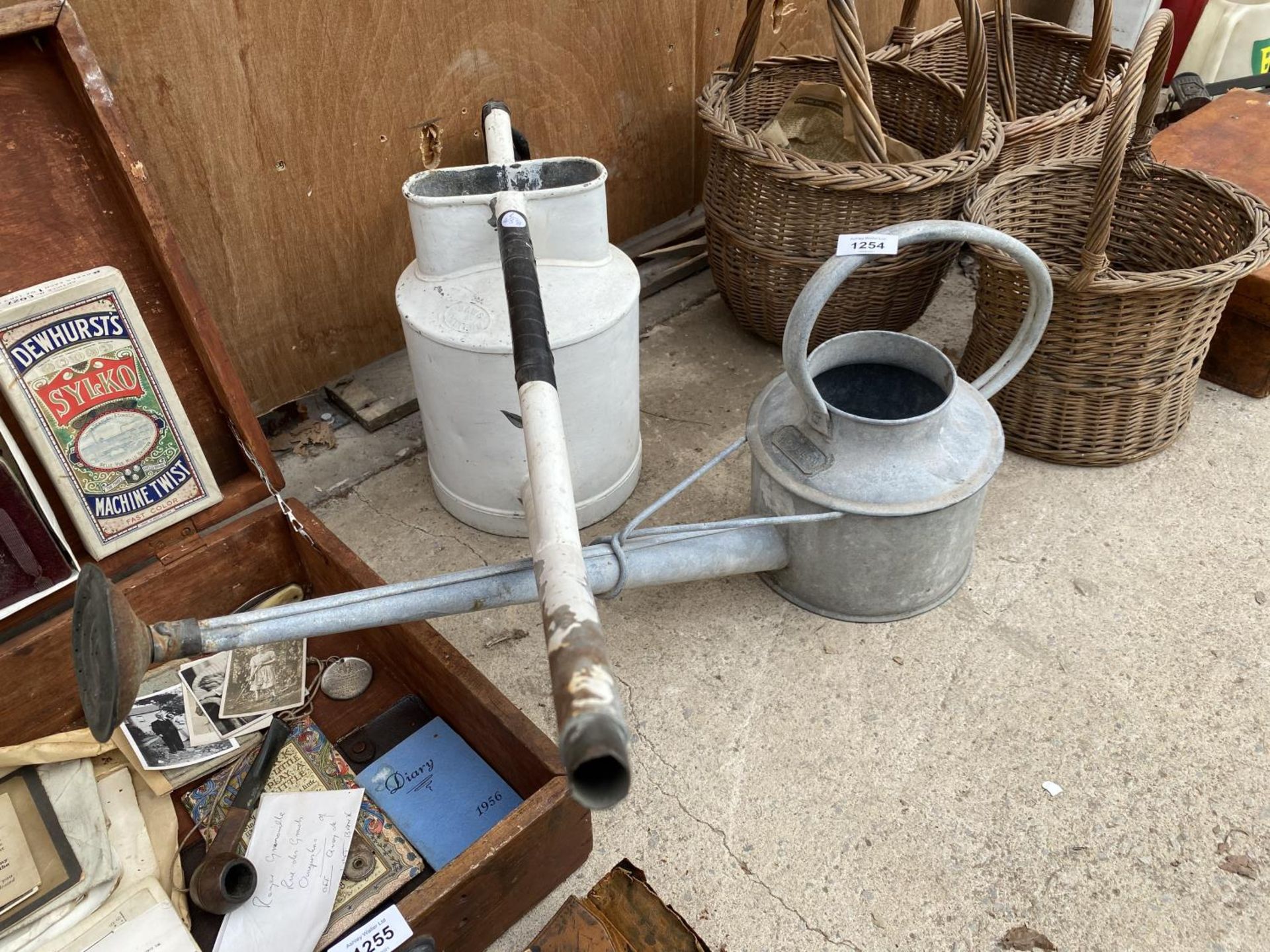 A GALVANISED LONG REACH WATERING CAN AND A FURTHER PAINTED LONG REACH WATERING CAN