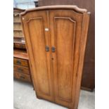 A SMALL OAK WARDROBE WITH TWO DOORS
