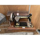 A VINTAGE SINGER SEWING MACHINE WITH WOODEN CARRY CASE AND KEY