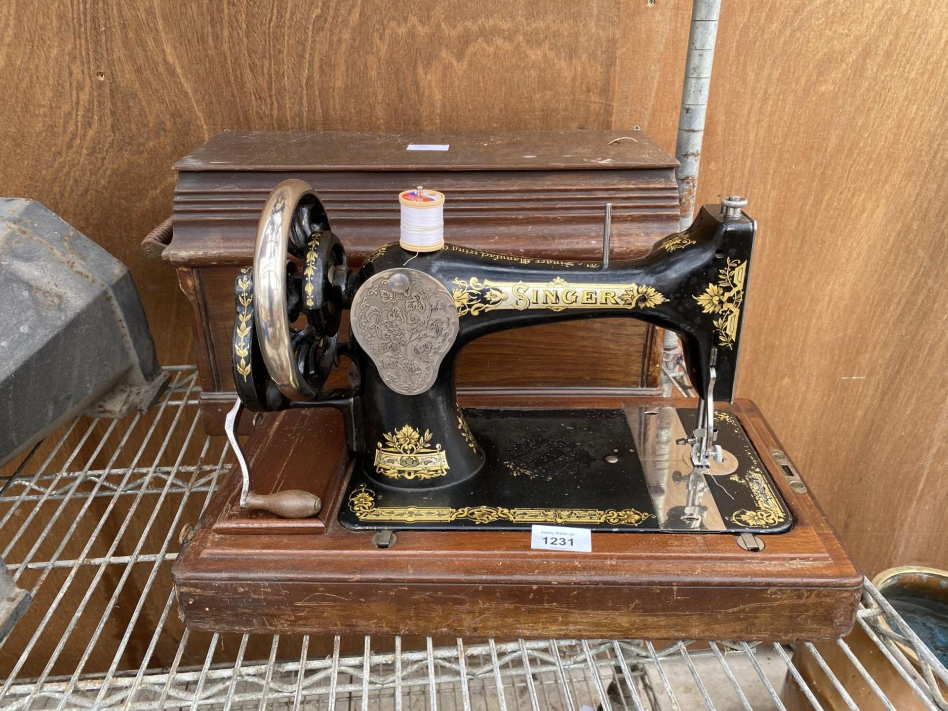 A VINTAGE SINGER SEWING MACHINE WITH WOODEN CARRY CASE AND KEY