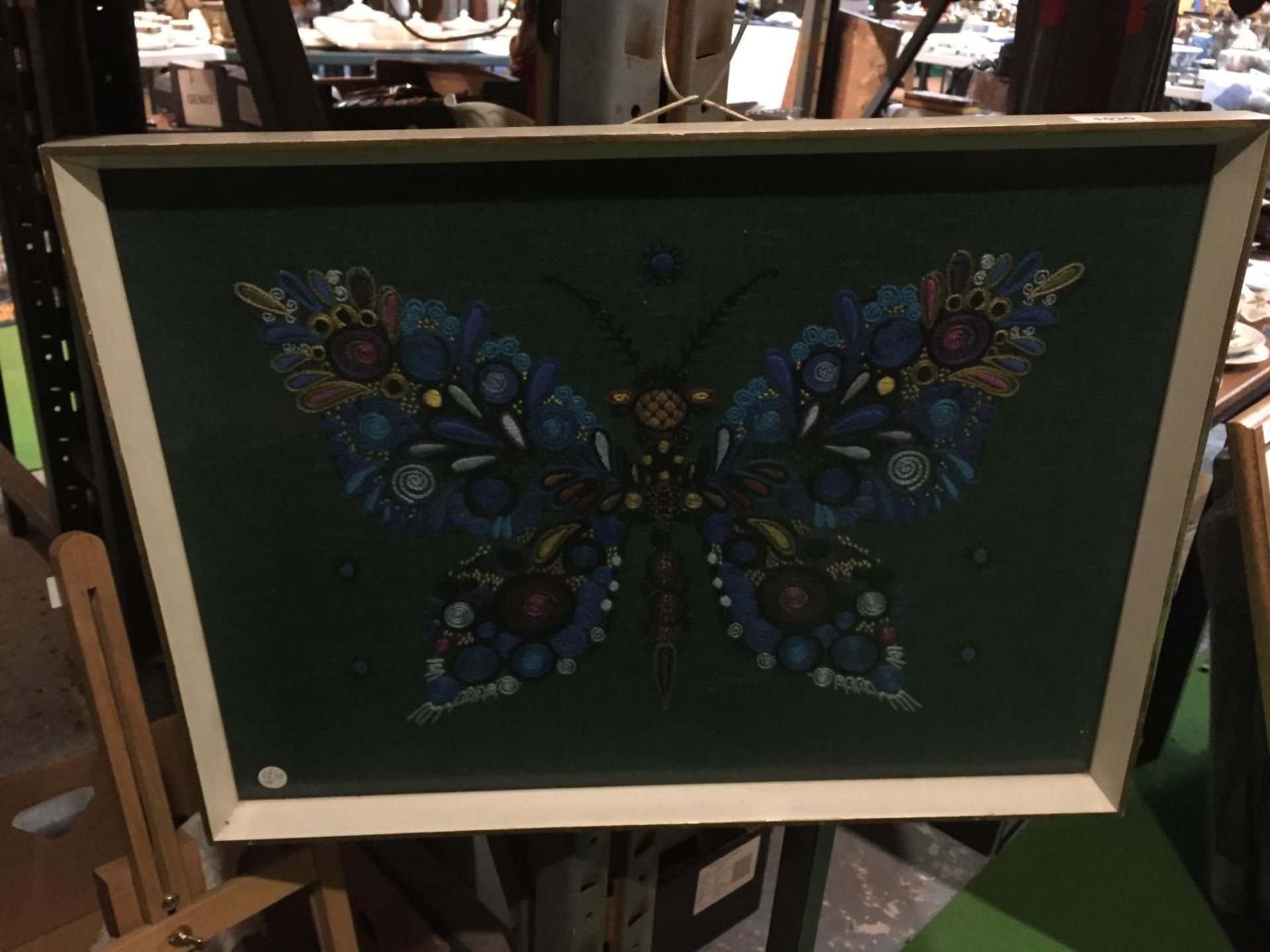 A FRAMED NEEDLEWORK OF A BUTTERFLY