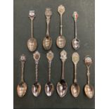 TEN COLLECTABLE WHITE METAL TEASPOONS