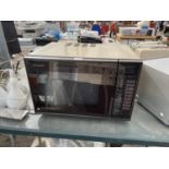 A PANASONIC MICROWAVE OVEN BELIEVED IN WORKING ORDER BUT NO WARRANTY