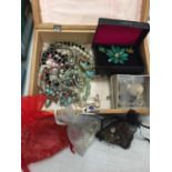 A TREEN BOX OF COSTUME JEWELLERY CONSISTING OF NECKLACES, BRACELETS, EARRINGS ETC