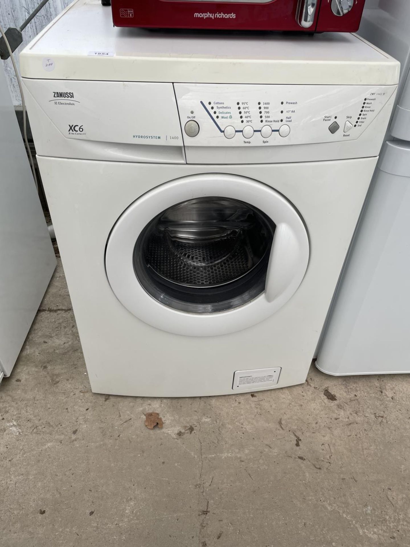 A WHITE ZANUSSI WASHING MACHINE BELIEVED IN WORKING ORDER BUT NO WARRANTY