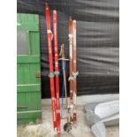 TWO SETS OF WOODEN SKIS AND A COLLECTION OF SKI POLES