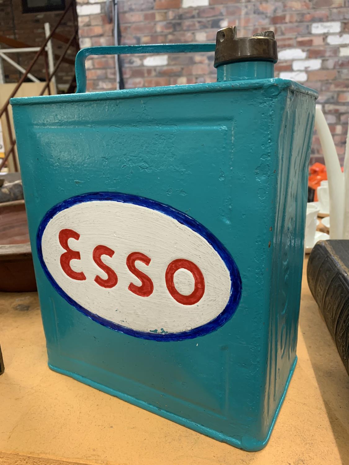 AN ESSO PAINTED PETROL CAN WITH BRASS CAP