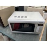 A SILVER INVERTER MICROWAVE BELIEVED IN WORKING ORDER BUT NO WARRANTY