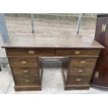 A MID 20TH CENTURY TWIN PEDESTAL DESK ENCLOSING 8 DRAWERS WITH MILITARY STYLE HANDLES 46" X 19"