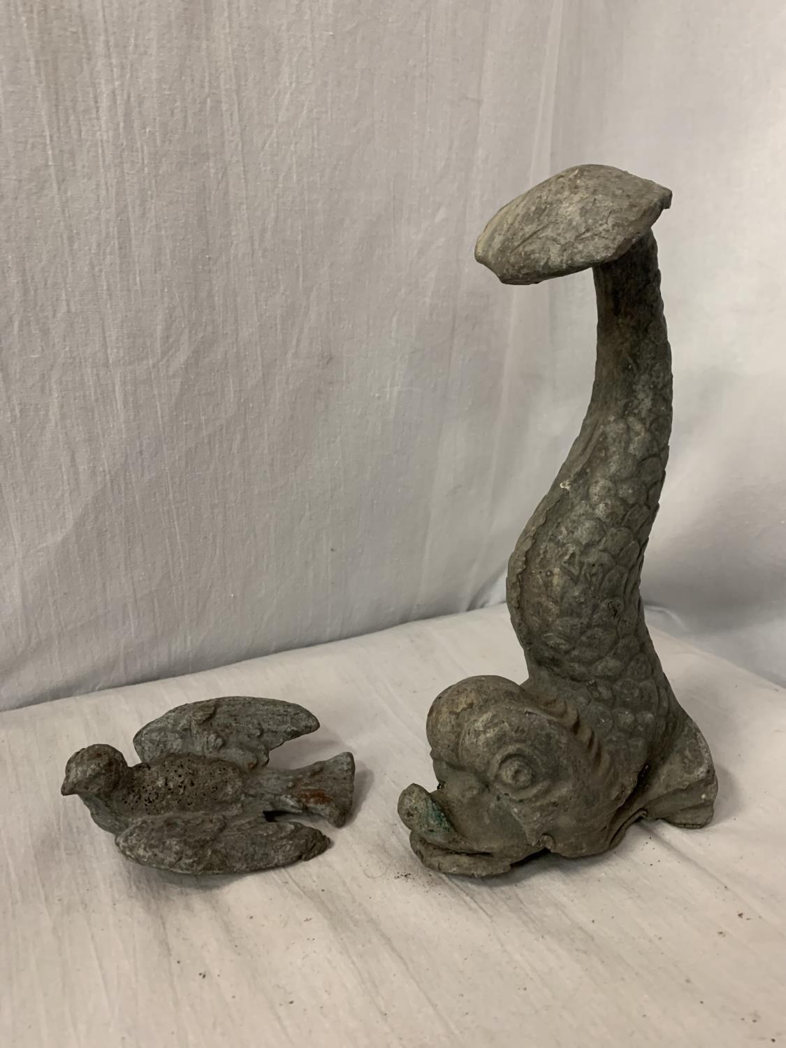 A LEAD DOOR STOP IN THE FORM OF A MYTHICAL FISH AND A LEAD BIRD IN FLIGHT - FISH H:26CM BIRD L:12CM