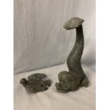 A LEAD DOOR STOP IN THE FORM OF A MYTHICAL FISH AND A LEAD BIRD IN FLIGHT - FISH H:26CM BIRD L:12CM