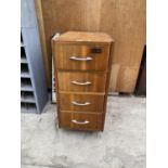 A VINTAGE WOODEN FOUR DRAWER FILING CABINET