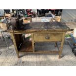 A VINTAGE WORK BENCH WITH LOWER SHELF ENCLOSING A SINGLE DRAWER AND WITH A PARKINSONS BENCH VICE