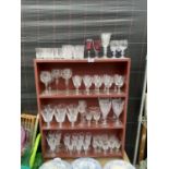 A LARGE QUANTITY OF GLASS WARE TO INCLUDE SHERRY GLASSES, WINE GLASESS ETC