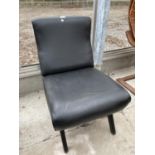 A BLACK LEATHER EFFECT FIRESIDE CHAIR