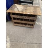 AN INDUSTRIAL STYLE OCCASIONAL TABLE MADE FROM POTATO BOXES WITH LOWER WINE RACK