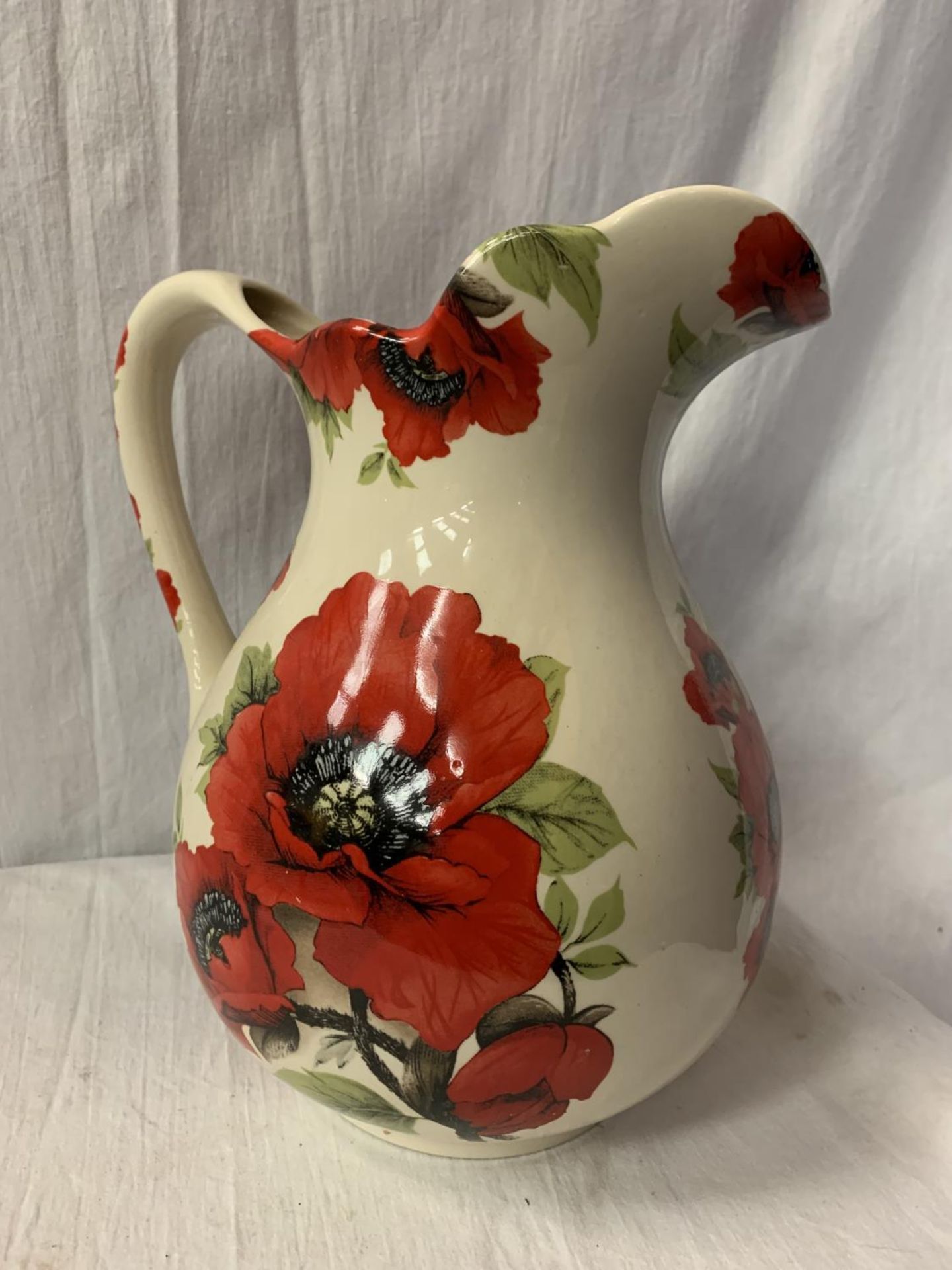 A VERY LARGE JUG BY HERON CROSS POTTERY WITH POPPY DETAIL H: 29CM