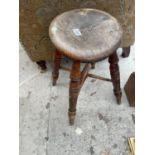 A VICTORIAN ROUND STOOL ON FOUR TURNED LEGS