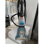A VAX RAPID DELUXE CARPET WASHER BELIEVED IN WORKING ORDER BUT NO WARRANTY