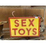 AN ILLUMINATED 'SEX TOYS' SIGN