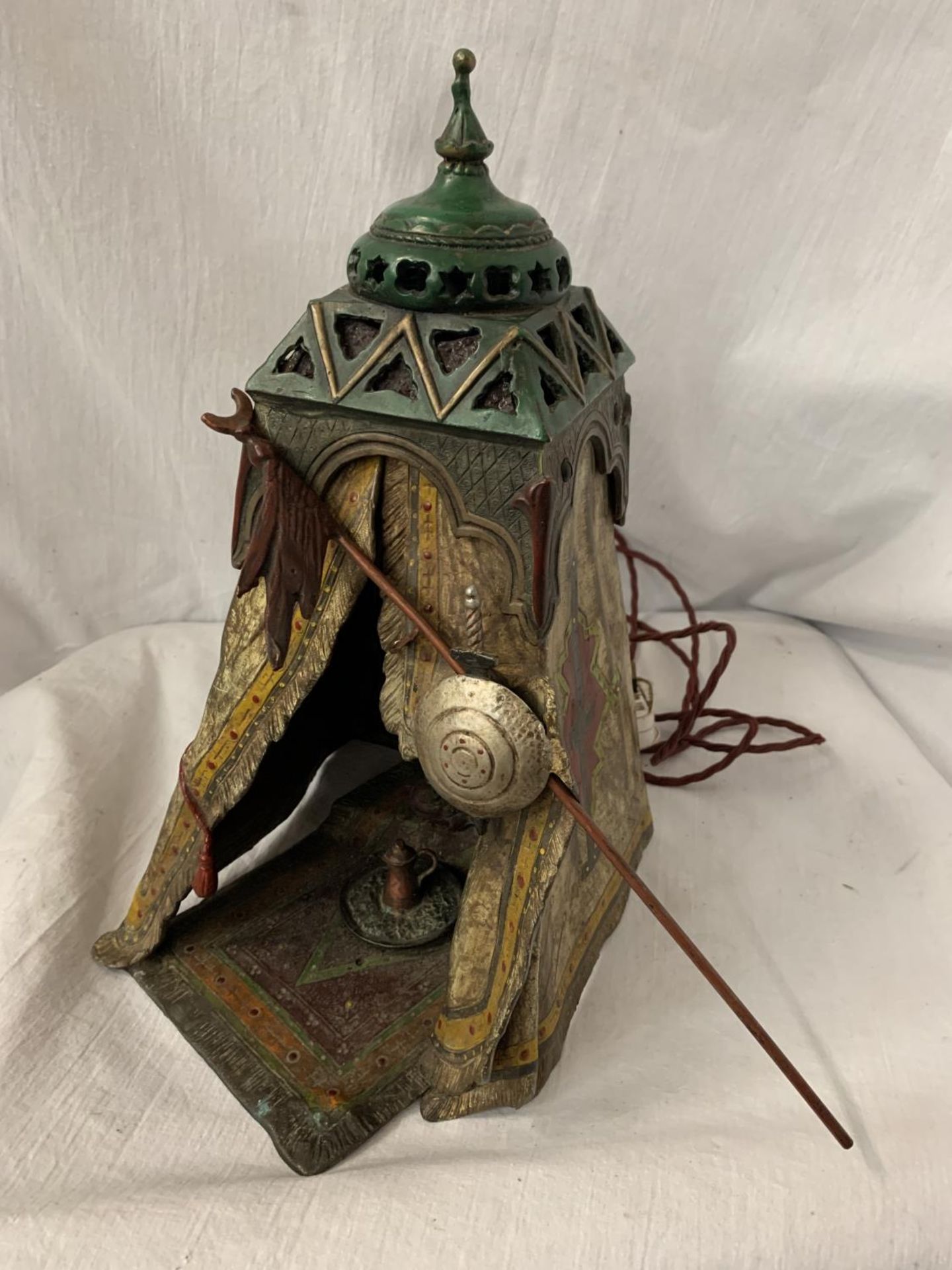 A BERGMAN STYLE COLD PAINTED BRONZE LAMP DEPICTING AN AFRICAN TRIBESMAN IN A TENT - HEIGHT