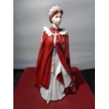 A ROYAL WORCESTER FIGURINE OF HER MAJESTY THE QUEEN