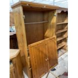 A MODERNPINE TWO DOOR WARDROBE WITH THREE DRAWERS TO THE BASE, 42" WIDE