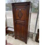 AN EARLY 20TH CENTURY OAK HALL WARDROBE WITH PANELED DOOR AND INTERNAL MIRROR, 30" WIDE