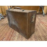 A VINTAGE LEATHER SUITCASE