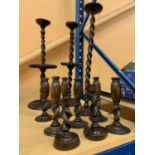 A SELECTION OF ELEVEN WOODEN CANDLESTICKS OF VARIOUS SIZES THE TALLEST BEING 68CM HIGH AND THE